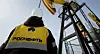 Rosneft employee looking at an oil well