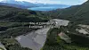 Panoramautsikt over dal og fjell med et industriområde som er merket som stedet for OpenAIs europeiske gigafabrikk.