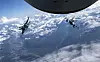 Two Japan Air Self-Defense Forces F-2 pilots fly behind a KC-135 Stratotanker