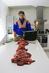 Issát Turi with the complete spine of a reindeer, ready for cooking. (Photo Caption: Anders Oskal)