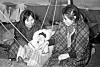 Two Inuit women in a tent with a baby, near Inukjuak, Quebec, in 1947-1948. (Photo: Richard Harrington/Library and Archives Canada/PA-147312)