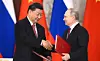xi and putin shaking hands